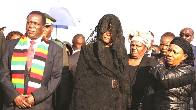 Another Grace Mugabe-Lacoste Drama? Amai covers face at Harare Airport, Blue roof funeral pictures
