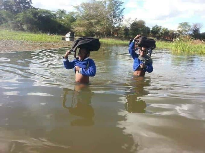 Heart breaking pictures: South African poor school kids cross flooded river on foot