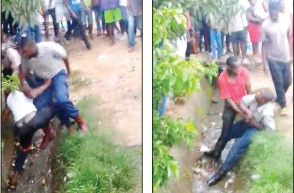 ZRP cops bashed by members of the public, thrown into sewage water..VIDEO