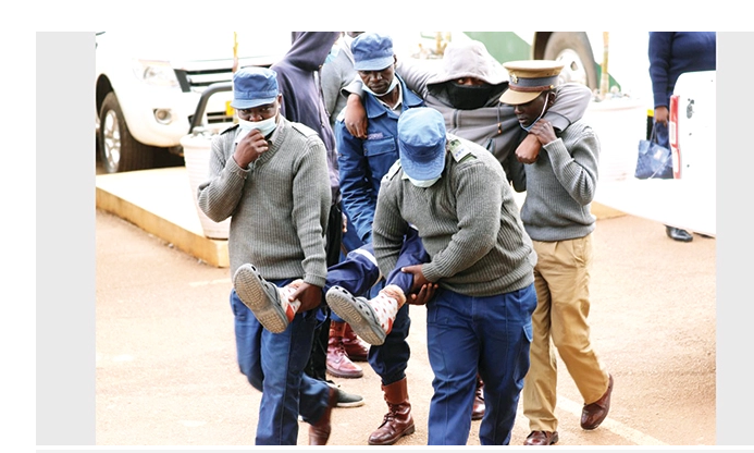 Murder accused police officers carried into court