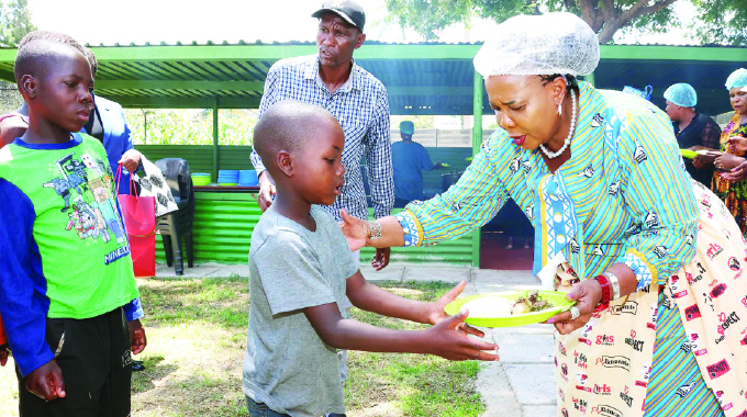 First Lady Auxillia Mnangagwa cooks for street kids
